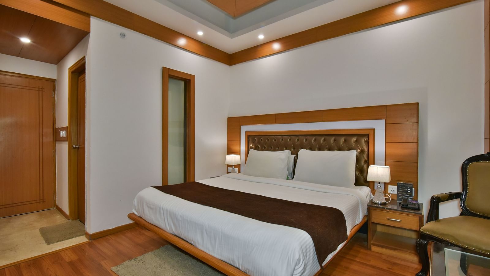 A large bed in Luxury Room Without Balcony at DLS Highland Resort and Spa, Mussoorie.